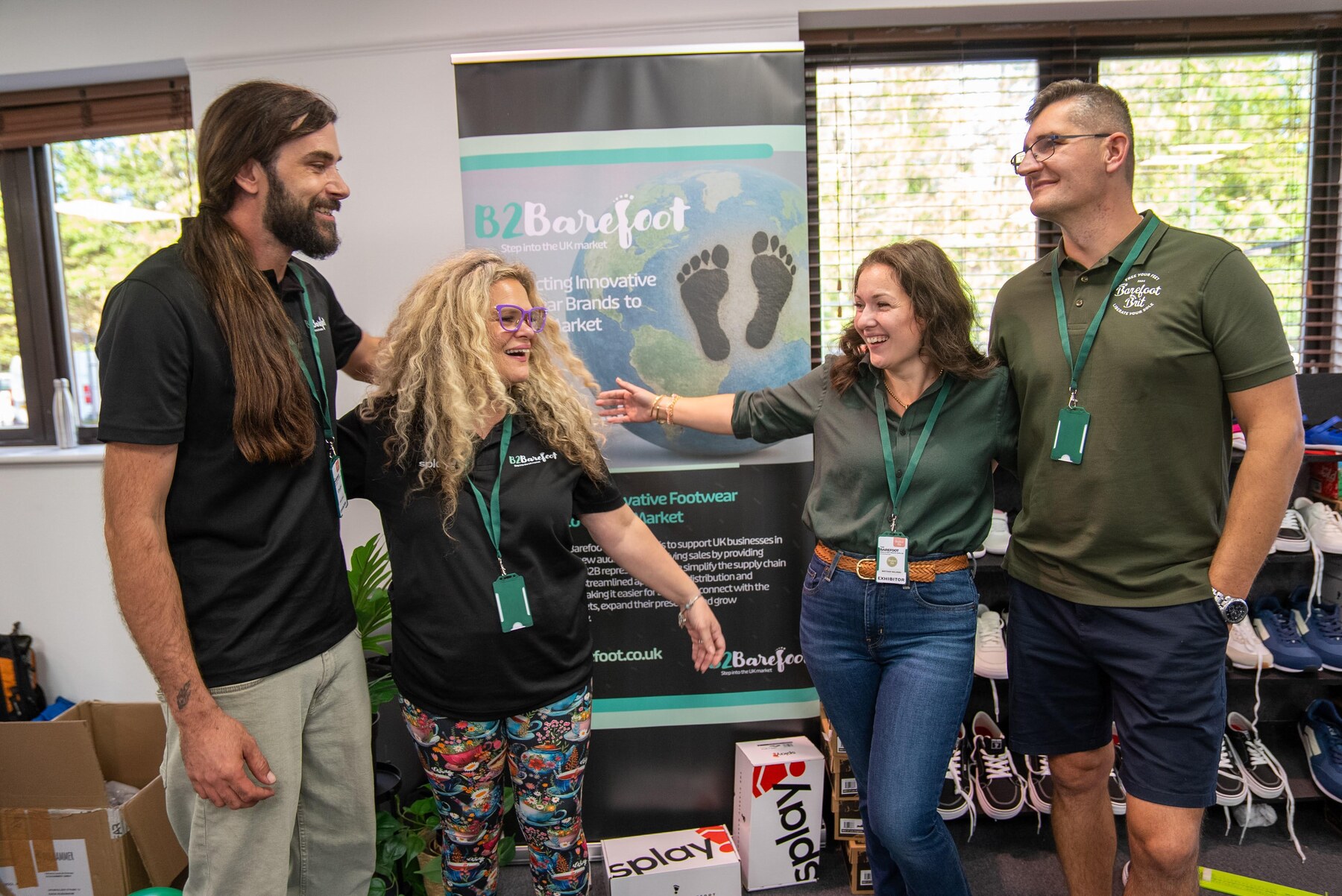 Four exhibitors sharing a laugh at the B2Barefoot stand, photo by Barefoot Brit Expo