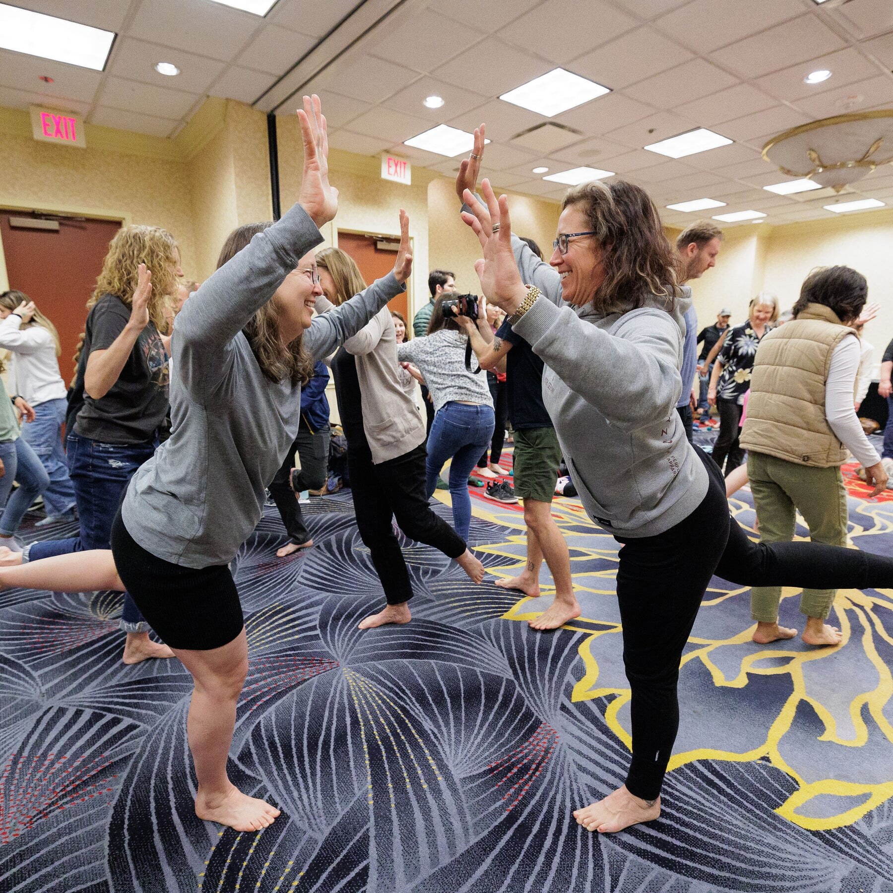 Workshop participants practising balance exercises together, photo by Barefoot Shoe Expo