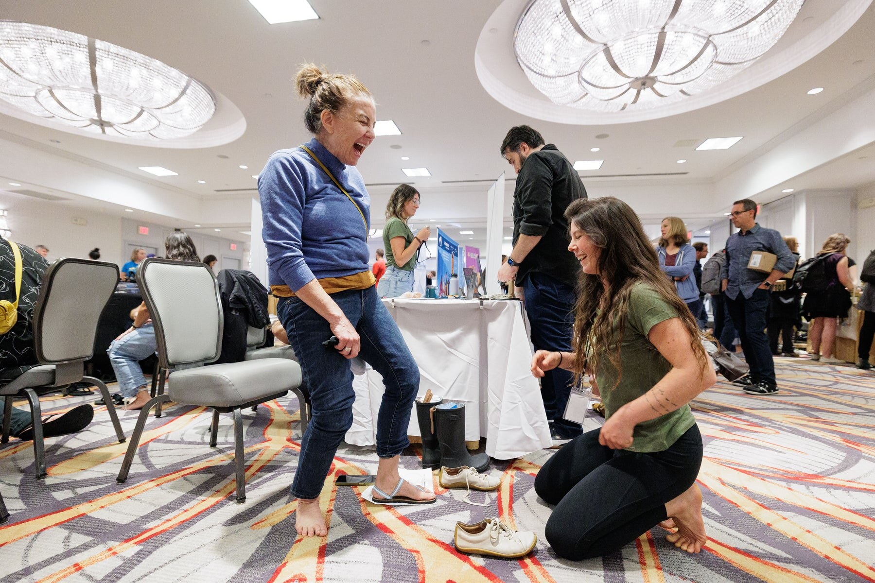 Visitors laughing while trying foot and balance activities, photo by Barefoot Shoe Expo