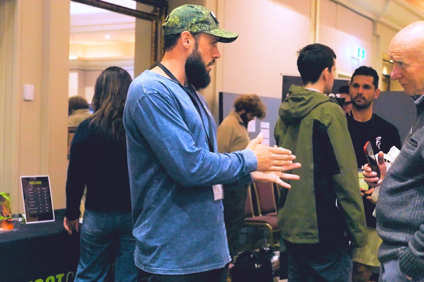 Visitors and exhibitors chatting in the hotel ballroom, photo by The Foot Collective